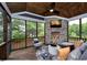 Cozy screened porch with a stone fireplace, wood ceiling, comfortable seating, and wooded views at , Efland, NC 27243