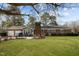 Expansive backyard with a brick home featuring a patio perfect for outdoor entertaining at 102 Trinity Dr, Elon, NC 27244
