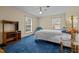 Bedroom features blue carpet, a brass bed frame and two large windows at 102 Trinity Dr, Elon, NC 27244