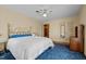 Bedroom featuring blue carpet, gold bed frame and a ceiling fan at 102 Trinity Dr, Elon, NC 27244