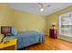Bedroom featuring yellow walls, hard wood floors and a ceiling fan at 102 Trinity Dr, Elon, NC 27244