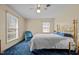 Bedroom featuring blue carpet, brass bed frame, and bright natural light at 102 Trinity Dr, Elon, NC 27244