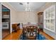 Classic dining room with wooden furniture, a chandelier, and views into the kitchen at 102 Trinity Dr, Elon, NC 27244