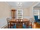 Elegant dining room with a chandelier, wooden table and chairs, and patterned wallpaper at 102 Trinity Dr, Elon, NC 27244