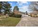 Traditional brick home with a two-car garage and a sprawling driveway in a serene setting at 102 Trinity Dr, Elon, NC 27244