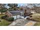 Brick home with a two-car garage and a concrete patio, set against a backdrop of bare trees at 102 Trinity Dr, Elon, NC 27244