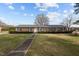 Charming brick home featuring well-manicured hedges and a mature tree at 102 Trinity Dr, Elon, NC 27244