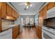 Open kitchen with wooden cabinetry and appliances, flowing into a dining area at 102 Trinity Dr, Elon, NC 27244