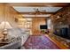Comfortable living room featuring wood paneling, a fireplace, and ample seating at 102 Trinity Dr, Elon, NC 27244
