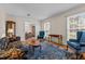 Bright living room with hardwood floors, a large rug, and lots of natural light at 102 Trinity Dr, Elon, NC 27244