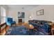 Comfortable living room featuring wood floors, blue furniture, and a decorative rug at 102 Trinity Dr, Elon, NC 27244