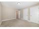 Empty bedroom features neutral carpet and has two closet doors at 104 Coats Ridge Dr, Benson, NC 27504