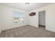 Bright bedroom features neutral carpet, large window and an open closet at 104 Coats Ridge Dr, Benson, NC 27504