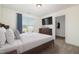 Staged bedroom with neutral carpet, large window, closet, and dresser at 104 Coats Ridge Dr, Benson, NC 27504