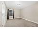 Empty bedroom with neutral carpet features large window with dark curtains at 104 Coats Ridge Dr, Benson, NC 27504