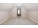 Angled walls add character to this carpeted bonus room with neutral colors and a window at 104 Coats Ridge Dr, Benson, NC 27504