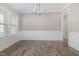 Empty dining room featuring classic wainscoting and ample natural light through large windows at 104 Coats Ridge Dr, Benson, NC 27504