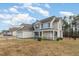 Inviting two-story home with a covered front porch and a well-maintained lawn at 104 Coats Ridge Dr, Benson, NC 27504