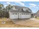 Side view of the large three-car garage featuring an extensive driveway at 104 Coats Ridge Dr, Benson, NC 27504