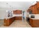 Well-lit kitchen featuring granite countertops, stainless steel appliances, and rich wood cabinetry at 104 Coats Ridge Dr, Benson, NC 27504