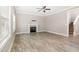 Inviting living room featuring a cozy fireplace, ceiling fan, and neutral color palette at 104 Coats Ridge Dr, Benson, NC 27504