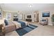 Spacious main bedroom featuring neutral tones, a ceiling fan, a TV, and a private seating area at 104 Coats Ridge Dr, Benson, NC 27504