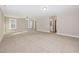Large bedroom with neutral carpeting, a ceiling fan, and plenty of natural light through big windows at 104 Coats Ridge Dr, Benson, NC 27504