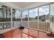 Beautiful screened in porch with varnished wood flooring and view of backyard at 104 Coats Ridge Dr, Benson, NC 27504