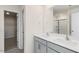 This bathroom features double sinks, a large mirror, and tile flooring at 106 Paper Birch Way, Fuquay Varina, NC 27526