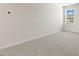 This bedroom features neutral carpet, white walls, and a bright window at 106 Paper Birch Way, Fuquay Varina, NC 27526