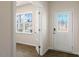 Bright foyer features elegant door with glass insert and sidelight window, and a storm door at 106 Paper Birch Way, Fuquay Varina, NC 27526
