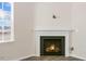 Close up of the fireplace in the living room with a window and light hardwood floors at 106 Paper Birch Way, Fuquay Varina, NC 27526