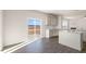 Bright kitchen features an island, grey cabinetry, tile backsplash and sliding door access to the backyard at 106 Paper Birch Way, Fuquay Varina, NC 27526