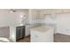 This kitchen features an island, granite countertops, stainless appliances, and seamlessly opens to the living area at 106 Paper Birch Way, Fuquay Varina, NC 27526