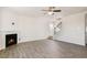 Light-filled living room features hardwood floors, a ceiling fan, and a cozy fireplace at 106 Paper Birch Way, Fuquay Varina, NC 27526