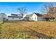 Expansive backyard with a classic white house and a play set, perfect for outdoor activities at 107 N 12Th St, Erwin, NC 28339