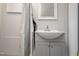 The bathroom is white with a grey vanity and a shower with a grey curtain at 107 N 12Th St, Erwin, NC 28339