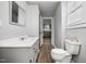 Well-lit bathroom with a white toilet at 107 N 12Th St, Erwin, NC 28339