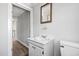 Bathroom includes a classic mirror, sink, and a view into the hallway at 107 N 12Th St, Erwin, NC 28339