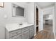 Bathroom featuring a white vanity and cabinet with a view into kitchen at 107 N 12Th St, Erwin, NC 28339