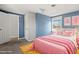 Pink-themed bedroom featuring a bed, bedside table, and a large window at 107 N 12Th St, Erwin, NC 28339