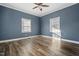 Bedroom features vinyl floors, a ceiling fan, and two windows at 107 N 12Th St, Erwin, NC 28339