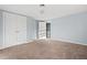 Bedroom featuring carpeting, double closets, and an open doorway at 107 N 12Th St, Erwin, NC 28339