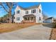 Two-story home featuring white siding, black shutters, and a detached garage at 107 N 12Th St, Erwin, NC 28339