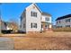 White two-story home with black shutters and a small front porch at 107 N 12Th St, Erwin, NC 28339