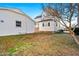 Back exterior of a white home with a partial view of backyard and trees at 107 N 12Th St, Erwin, NC 28339