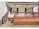 Close-up of the front porch with brick base and wood railings at 107 N 12Th St, Erwin, NC 28339