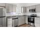 Well-lit kitchen with stainless steel appliances and gray cabinets at 107 N 12Th St, Erwin, NC 28339