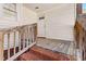 Charming porch with weathered wooden planks, brick steps, and a white door, offering a warm welcome at 107 N 12Th St, Erwin, NC 28339
