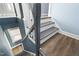 Wooden staircase with painted risers and a contrasting handrail at 107 N 12Th St, Erwin, NC 28339